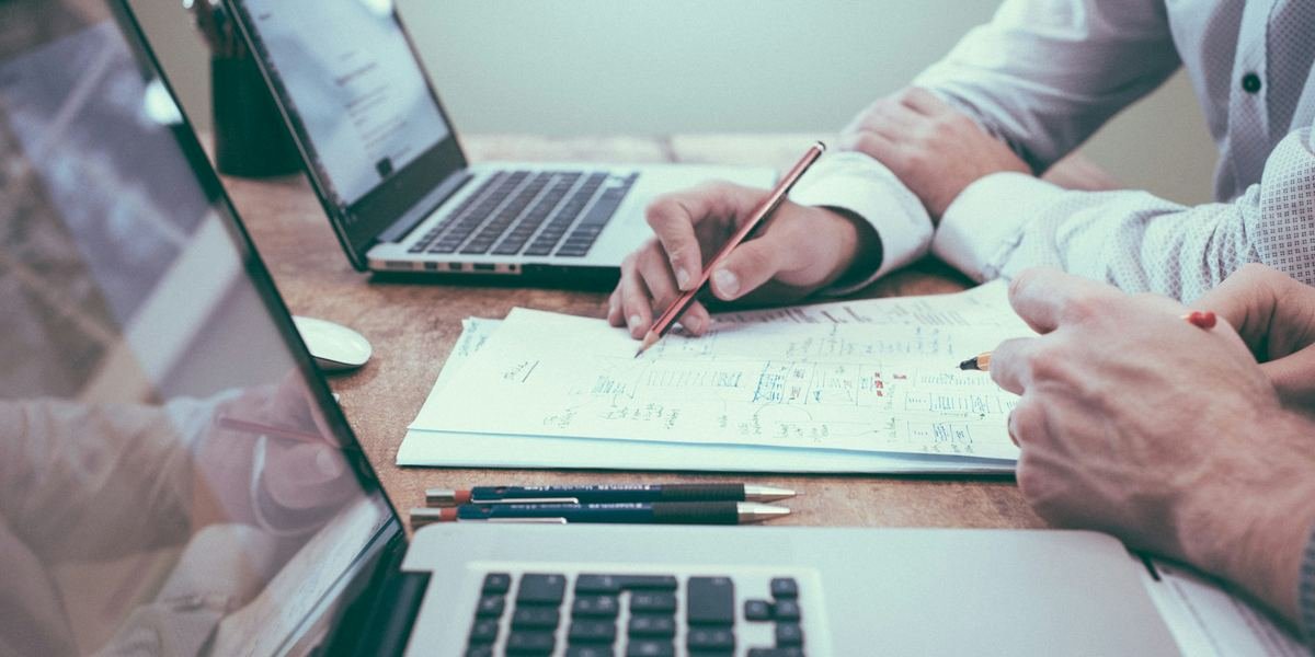Financial reports and charts on a laptop