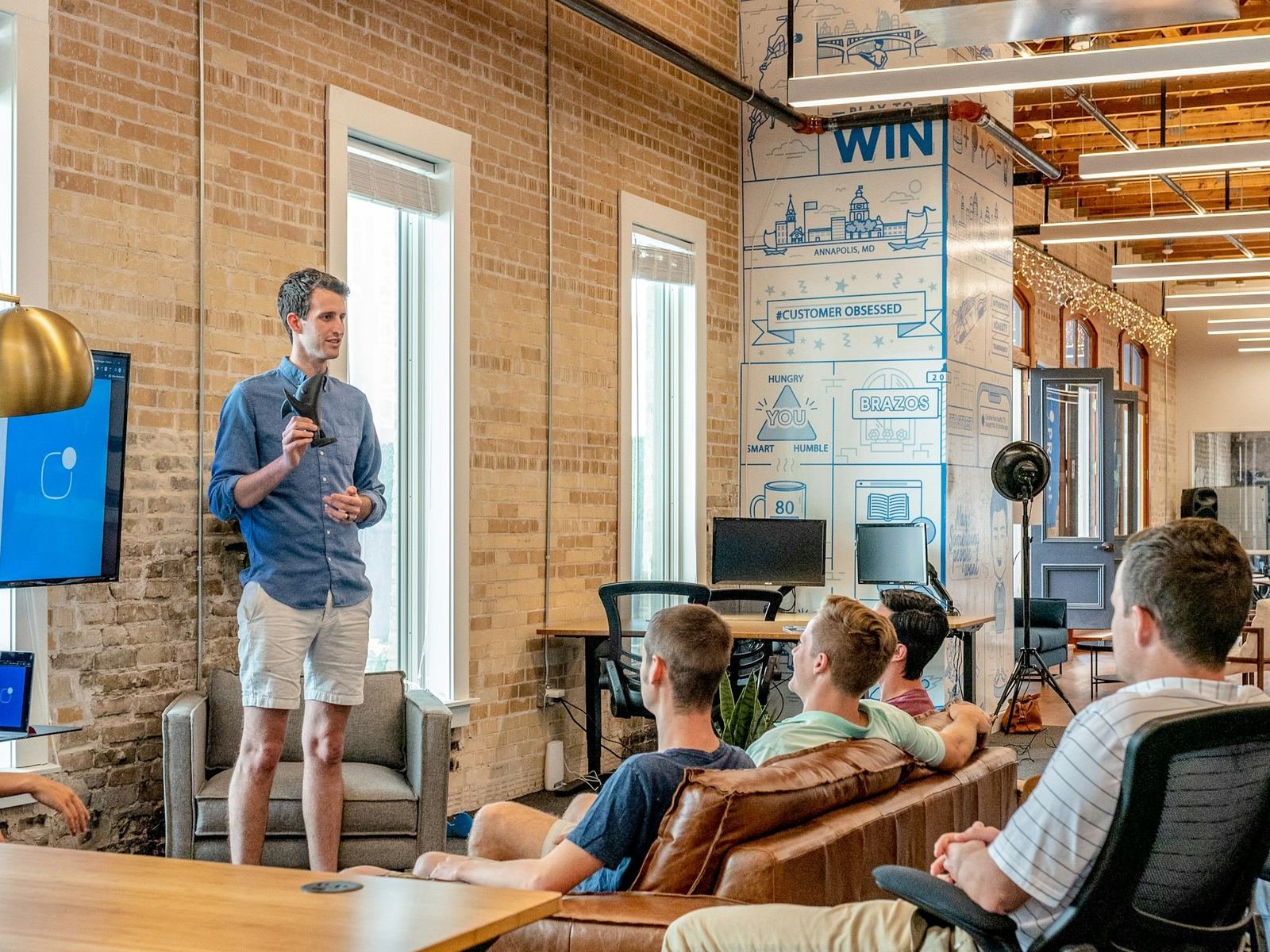Client team working together in their office (customer success slide)